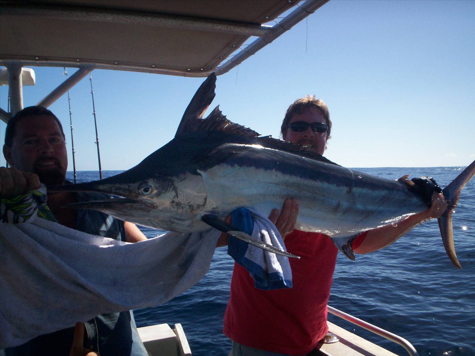 my dad (on the right) with 70kg+  black marlin  caught with 20kg rod