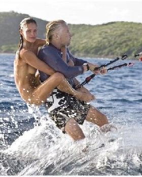 Richard Branson with naked model on his back