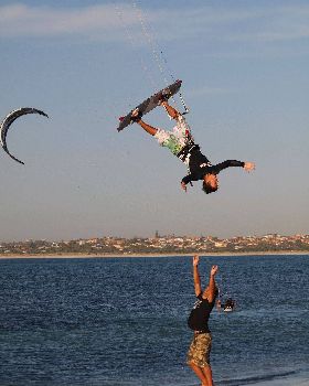 Simon Deadman over dude on beach