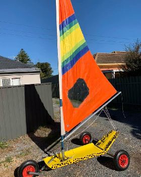 Mini with a deep and pointy Windsurfer sail with a bit chopped off the bottom