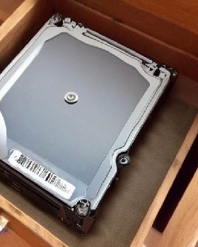 1165188866-old hard drive sitting in a dusty chest of drawers