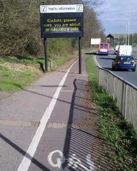 funny-sign-cyclists-ride-pole-street