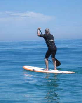 Dave paddles off to the lineup