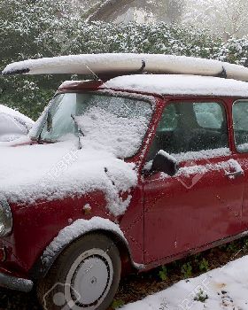 12616278-surfboard-on-a-car-roof-covered-by-snow-Stock-Photo