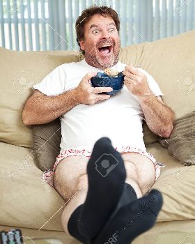 37126500-Middle-aged-man-in-his-underwea-watching-TV-and-eating-cereal-He-s-laughing-at-what-s-on-te