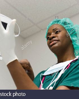 nurse-putting-on-latex-gloves-BTEHMN
