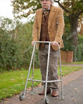 grey-haired-old-man-walking-along-with-his-zimmerframe-walking-aid-DGFH7A