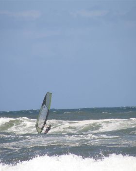 heading out in light onshore mush on a freestyle board
