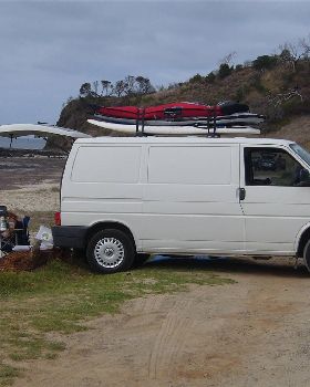 VW Transporter with boards on roof