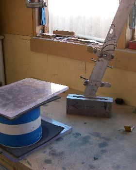 Vacuum tank for degassing resin, fin head mold in background