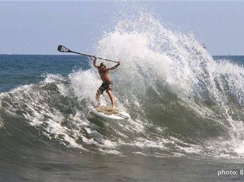 Backwash waves explode throwing SUP Surfer into the air - Stand Up Paddle News